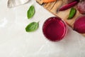 Glass with beet juice and ingredients on table, top view Royalty Free Stock Photo