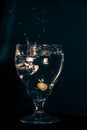 A glass on a black background, an olive drops in a glass with splashes