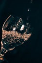 A glass on a black background, an olive drops in a glass with splashes