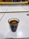 a glass of black coffee that adds enthusiasm
