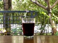 A glass of Black Coffee on green portrait background