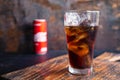 Glass of black soft drinks  and cans of soft drinks Royalty Free Stock Photo