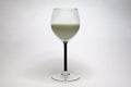 glass with a black stem and milk Royalty Free Stock Photo