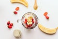 glass blender bowl filled with chopped fruit for a smoothie drink.