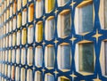 Glass block wall with wood of blue-yellow colors. Side view. Wall with pattern, texture