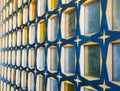 Glass block wall with wood of blue-yellow colors. Side view. Wall with pattern, texture Royalty Free Stock Photo