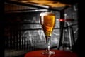 A glass of blond beer on a thin leg in a bar. Royalty Free Stock Photo