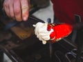 Glass-blower artist create white glass layer on transparent glass bowl