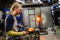 Two Women Shaping Blown Glass on the Blowpipe Royalty Free Stock Photo