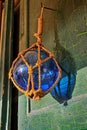 Glass blue buoy on old wood door Royalty Free Stock Photo