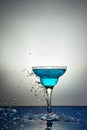 Glass with blue champagne or cocktail. Levitation Royalty Free Stock Photo