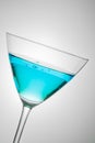 Glass with blue cocktail tilted