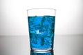 Glass of blue drink with ice cubes Royalty Free Stock Photo