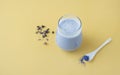 Glass of blue matcha latte and clitoria flowers on a yellow background