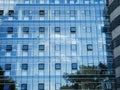 Glass blue square Windows of facade modern city business building skyscraper. Modern apartment buildings in new neighborhood. Royalty Free Stock Photo