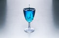 Glass with blue water on a table Royalty Free Stock Photo