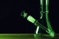 Glass bong on wooden table against black background, space for text. Smoking device Royalty Free Stock Photo