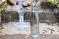 Glass bottle on the background of pure spring water. Natural water Royalty Free Stock Photo