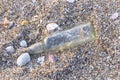 A glass bottle on the beach near the sea. It`s garbage pollution Royalty Free Stock Photo