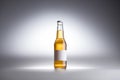 Glass bottle with beer and blank white label on grey background. Royalty Free Stock Photo