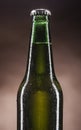 Glass bottle of beer on brown background Royalty Free Stock Photo