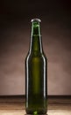 Glass bottle of beer on brown background Royalty Free Stock Photo