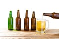 Glass and bottle of beer with no logos on wooden table isolated copy space, bottle mock up. Beer bottle studio shot with cap Royalty Free Stock Photo