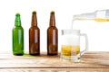 Glass and bottle of beer with no logos on wooden table isolated copy space, bottle mock up. Beer bottle studio shot with cap Royalty Free Stock Photo