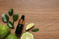 Glass bottle of bergamot essential oil and fresh fruits on wooden table, flat lay. Space for text Royalty Free Stock Photo