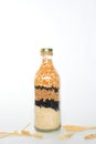 glass bottle with cereal grains rice, soy, beans, corn on white background