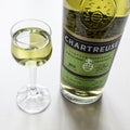 Glass and bottle of Chartreuse liqueur close up