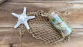 Star fish Sea glass in a bottle fishing on wood. Royalty Free Stock Photo