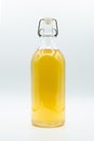 Glass bottle containing tea isolated on white background Royalty Free Stock Photo