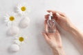 Glass bottle with cosmetic serum in female hands. beauty skincare concept.