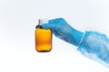 A glass bottle with cough syrup in the hands of a doctor, hands in medical gloves hold a bottle of antipyretic medicine on a white Royalty Free Stock Photo