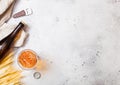 Glass and bottle of craft lager beer with raw wheat and opener on stone kitchen table background. Space for text. Top view Royalty Free Stock Photo