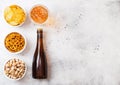 Glass and bottle of craft lager beer with snack on stone kitchen Royalty Free Stock Photo