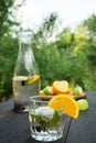 Glass and bottle with drink of mint and berries