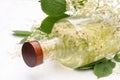 Glass bottle with elderflower syrup on a white wooden background Royalty Free Stock Photo