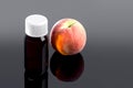 glass bottle of essential oil with fresh velvet peach. Royalty Free Stock Photo