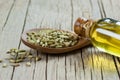 Glass bottle of fennel essential oil with fennel seeds in wooden spoon on wooden table Royalty Free Stock Photo