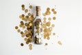 a glass bottle filled with golden coins amidst scattered coins, symbolizing unexpected wealth or treasure