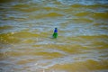 Glass bottle floating in ocean sea water Royalty Free Stock Photo