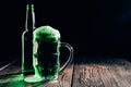 glass and bottle of green beer on wooden table, st patricks Royalty Free Stock Photo