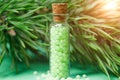 glass bottle with green granules and a pine branch. homeopathic remedies Royalty Free Stock Photo