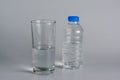 Glass and bottle with half water Royalty Free Stock Photo