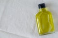 Glass bottle of hempseed oil on linen background with copy space