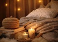 A glass bottle of home perfume stands adorned with wooden sticks, emanating a soothing fragrance. Scented candles emit