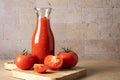 Glass bottle with homemade tomato sauce and ripe tomatoes Royalty Free Stock Photo
