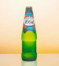 A glass bottle of Kronenbourg 1664 beer on a yellow background. Light beer is the main brand of Kronenbourg brewery, owned by the